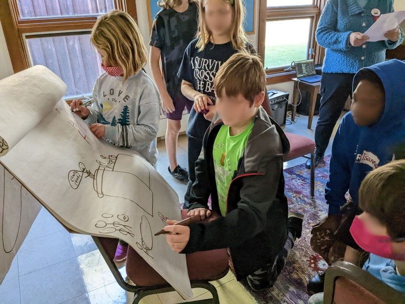 Children working together on a large drawing during a religious-education session